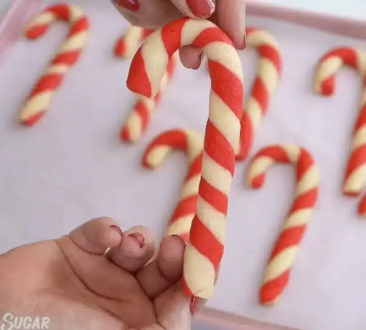 Festively decorated Candy Cane Cookies on a holiday plate