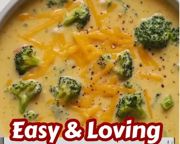 Bowl of simple homemade broccoli cheese soup garnished with cheese and broccoli florets.