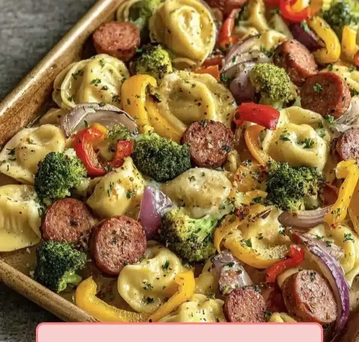 Crispy pierogies with smoky kielbasa and roasted vegetables on a plate.