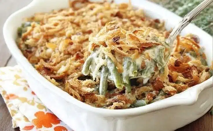Delicious green bean casserole topped with crispy onions, perfect for any holiday meal.