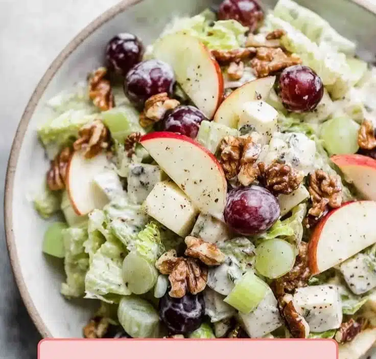 Delicious Waldorf Salad with apples, walnuts, and celery served in a bowl.