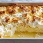 Lemon Cream Cheese Dump Cake topped with fresh lemon slices and whipped cream