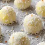 Soft coconut bites with lemon cream lava drizzled with coconut flakes
