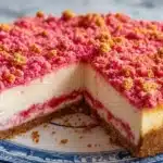 Delicious Strawberry Crunch Cheesecake dessert with strawberry topping and crunchy layers
